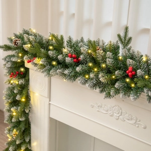 9FT Christmas garland with snow pine needles, berries and LED lights on white fireplace