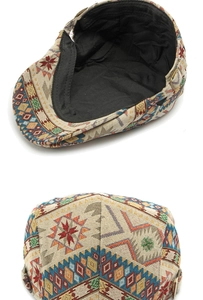 Detail view of ethnic jacquard flat cap showing colorful woven patterns and inner lining