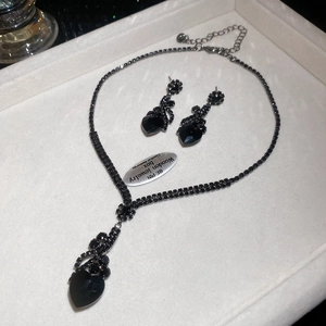 Elegant jewelry set with black crystal necklace and stud earrings in a white gift box