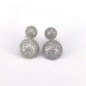 Detail of silver double ball earrings with micro-pave crystals in a minimalist style