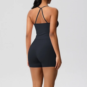 Detail of cross-back yoga top and high-waist fitness shorts in matte black fabric
