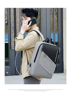 Close-up of side view showing built-in USB charging port on gray business backpack