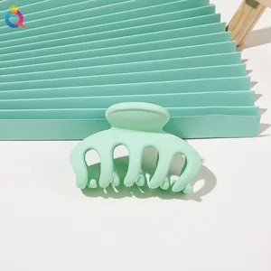 Detailed macro view of mint green matte hair claw clip with multi-tooth design for hair styling