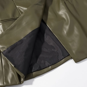 Close-up of olive green PU leather texture and black fabric lining on the jacket hem