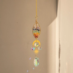 Brass heart tree of life suncatcher with chakra stones and crystal prisms hanging on wall