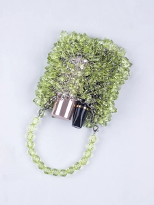 Detail of light green beaded handbag showing interior space and acrylic crystal beads