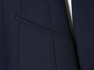 Detailed close-up of navy blue dress shirt dress with reinforced stitching on pocket