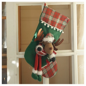 Detail of green Christmas stocking with 3D plush reindeer and plaid fabric accents