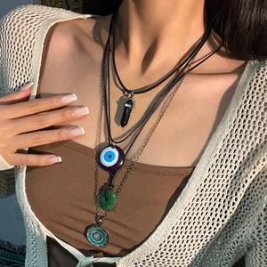 Bohemian multilayered necklace set with evil eye and mandala pendants on a model