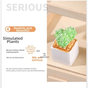 Close-up of artificial succulent in a white minimalist square pot for desk decoration