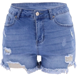 Close-up of blue distressed denim shorts with ripped details and raw frayed hems