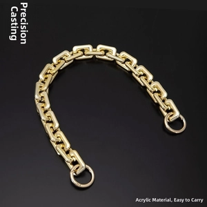 Detail of chunky gold acrylic chain strap with round snap hooks for handbags