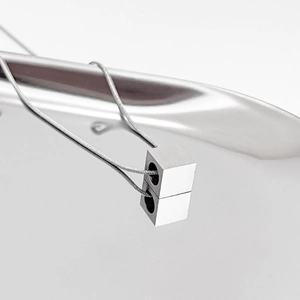 Macro shot of mirror-polished silver cube pendant on a fine snake chain necklace