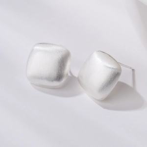 Minimalist silver square stud earrings with brushed matte finish on white background