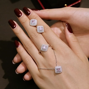 Luxury 925 silver jewelry set with pink square zirconia stones worn by a model