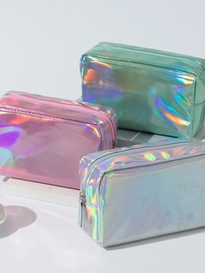 Vibrant laser PU makeup bags in pink, green, and blue with holographic finish on pedestals