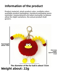 Detail view of a red plush monster keychain with yellow spiral limbs and dimensions info