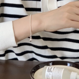 Minimalist S925 sterling silver beaded bracelet with heart knot charm on female wrist