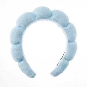 Detail of light blue sponge spa headband with thick cloud texture and soft plush fabric
