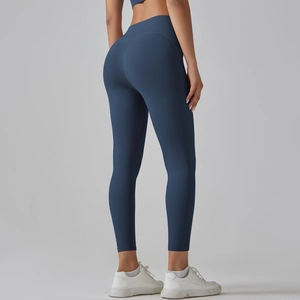 Close-up of the high-waisted design and seamless stitching on dark blue yoga leggings