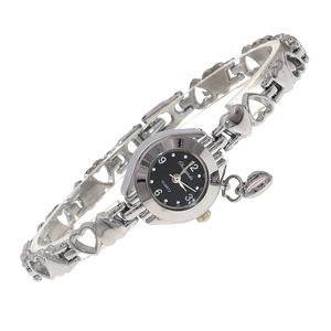 Detail of silver heart-shaped bracelet watch with black dial and dangling heart charm
