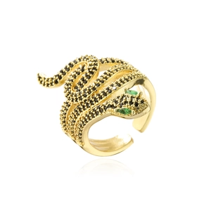 Macro shot of 18K gold plated snake ring with black pavé crystals and green gemstone eyes
