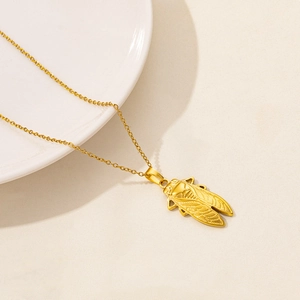 Close-up of golden cicada insect pendant with detailed wings on O-link chain