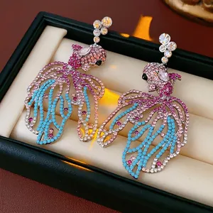 Vintage goldfish drop earrings with colorful crystals in a luxury jewelry display box