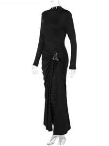 Detail of waist ruching and silver metallic buckle on a long-sleeve black maxi dress