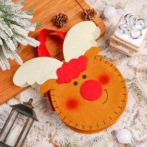 Creative Christmas reindeer felt gift bag with red handles on a snowy festive background