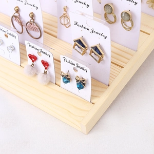 Solid wood tiered earring display stand with multiple slots for jewelry cards
