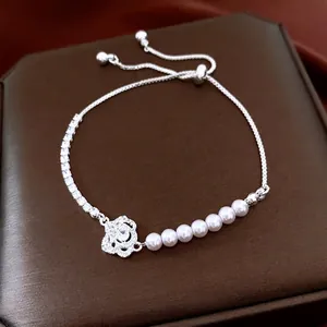 Elegant silver camellia flower pendant bracelet with white pearls and adjustable clasp