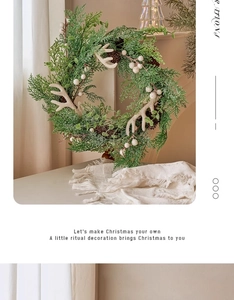 Detail of Christmas wreath with pine cones and white berries on a cozy beige table