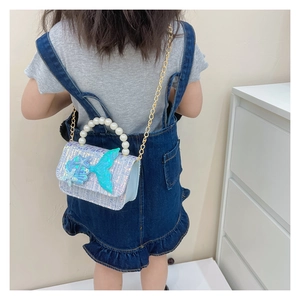Detail view of child sequin crossbody bag with pearl handle and mermaid tail design
