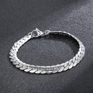 Polished stainless steel Cuban link bracelet with lobster clasp on dark background