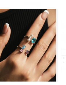 Close-up of S925 silver rings featuring blue crystal stones and elegant pearls