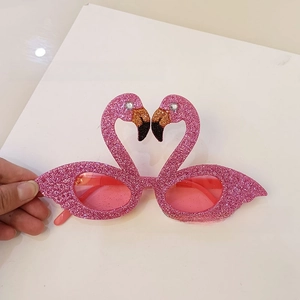 Pink flamingo party glasses with sparkling sequins and heart-shaped frames for beach events