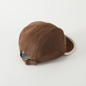 Detailed macro view of the brown camp hat with adjustable strap and vintage metal buckle