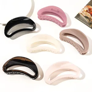 Detailed overhead view of six crescent hair claws in assorted matte and glossy finishes