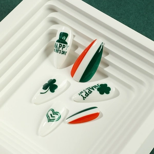 St. Patrick's Day press-on nails featuring shamrocks and hats in festive green and white
