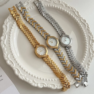 Vintage oval mother of pearl watches with herringbone metal straps in gold and silver