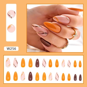 Medium almond press-on nails set with orange, brown colors and golden wavy glitter design