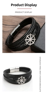 Detail of multi-layer black leather bracelet with silver nautical rudder anchor charm