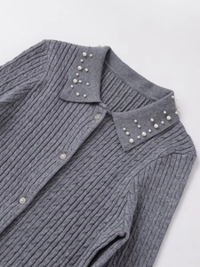 Detail of cable knit texture and faux pearl collar on this elegant grey cardigan