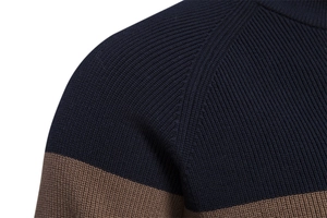 Detail of dark blue and brown knit cardigan showing raglan sleeve seams and fine texture