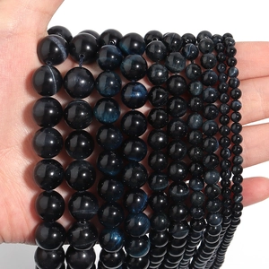 Detailed view of natural blue tiger eye loose beads in various sizes from 6mm to 14mm