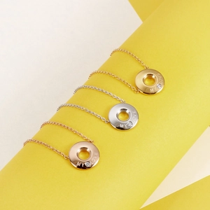 Detailed shot of My Love engraved rings in gold, silver, and rose gold with small zircons
