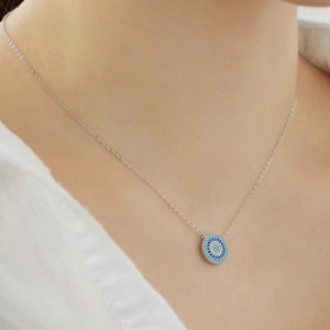 Close-up of S925 sterling silver evil eye necklace with blue and white crystals
