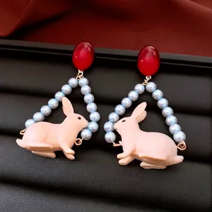 Handmade rabbit pendant earrings with red resin studs and pearl beads in a vintage style