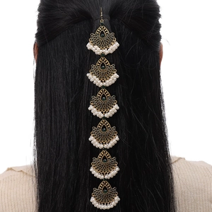Bohemian gold head chain with green gemstones and white pearls shown on a model